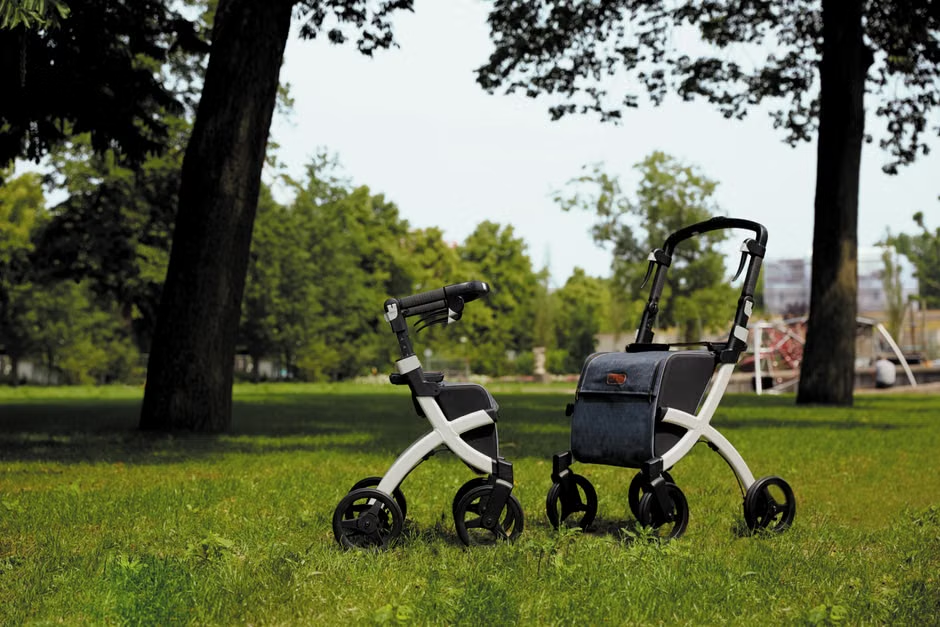 Lightweight 4-wheel compact rollator in a home hallway